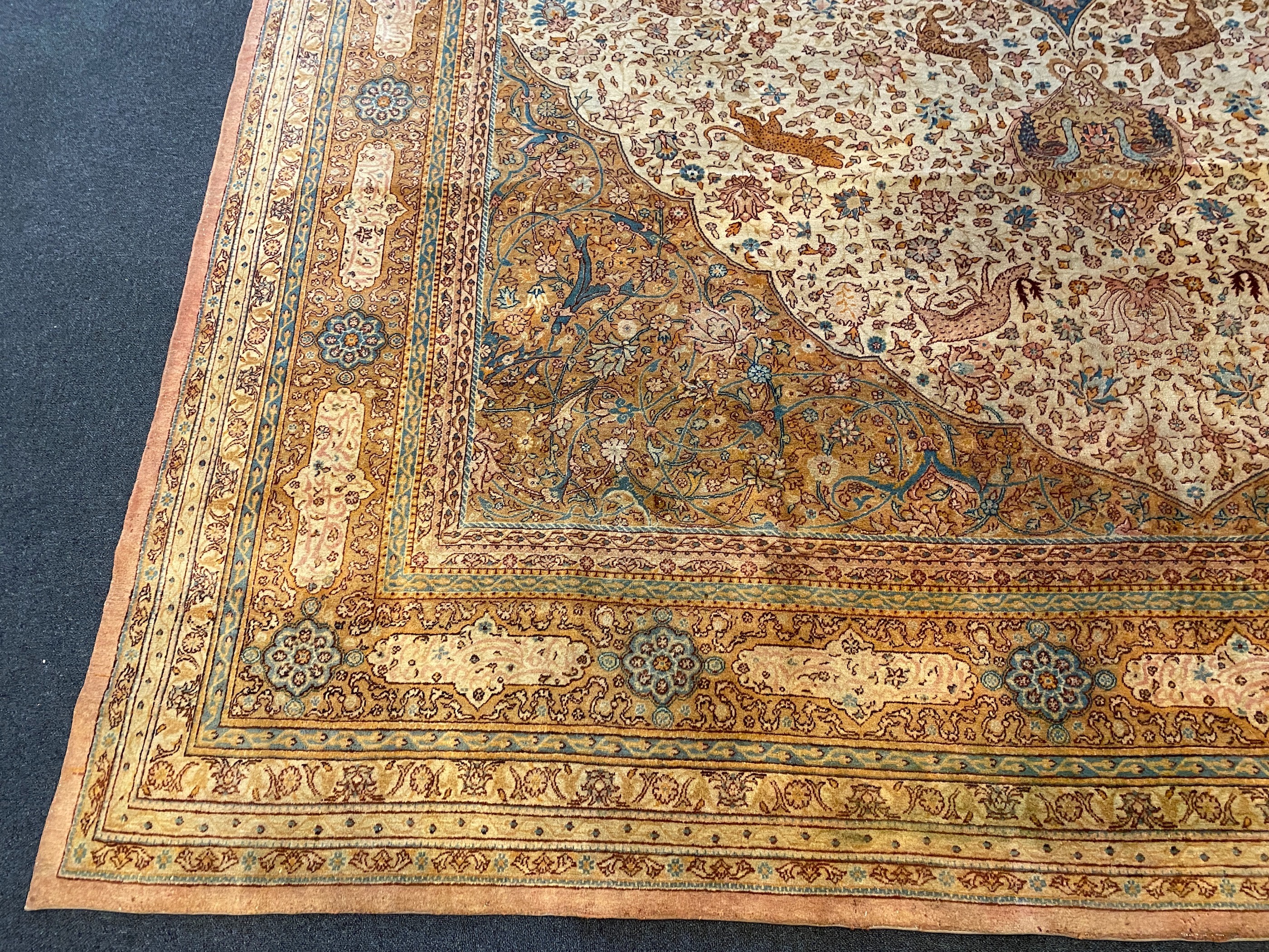 An early 20th century Tabriz ivory ground carpet, 528 x 348cm